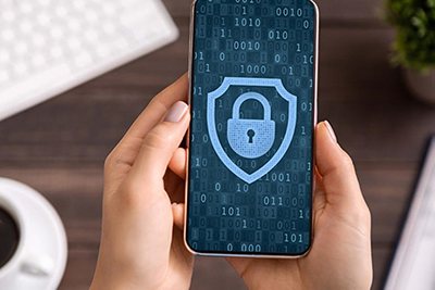 A mobile device displaying a blue padlock, surrounded by the outline of a shield against a background of 1s and 0s.