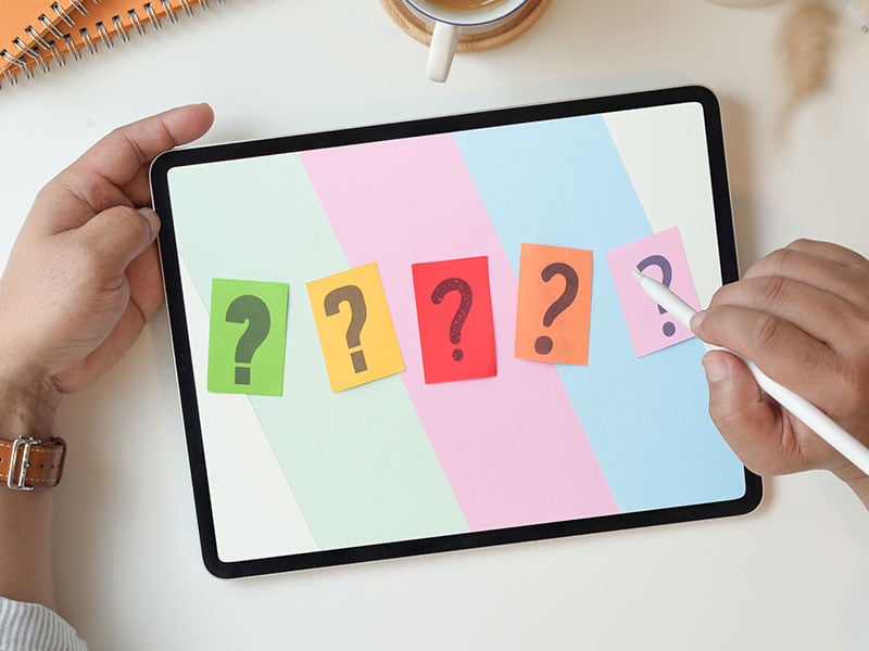 5 question marks on a tablet