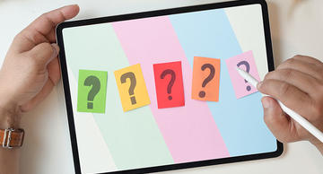 5 question marks on a tablet