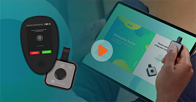 A play button is visible in the center of the image. To the right of the image, an over-the-shoulder view of a person's left hand holding a tablet in their lap while they press on their Digipass CX1 device in their right hand. To the left of the image, a DIGIPASS CX1 and CX2 overlap each other against a teal background that shows the silhouette of the OneSpan logo and obscured the remaining space in the photo