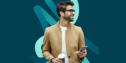 Man holding a phone and a coffee